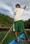 Boy steering our boat at 100 Islands, Philippines